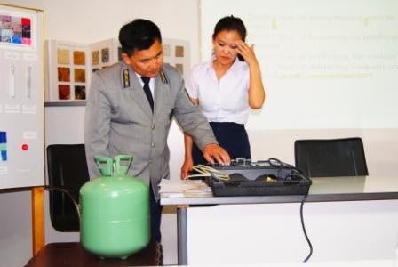 Mongolian customs official checking ODS canister for purity. Credit EIA.