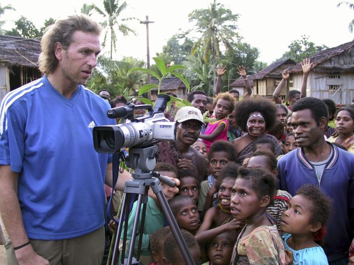 Julian Newman filming an event in Manggroholo village, West Papua, Indonesia.