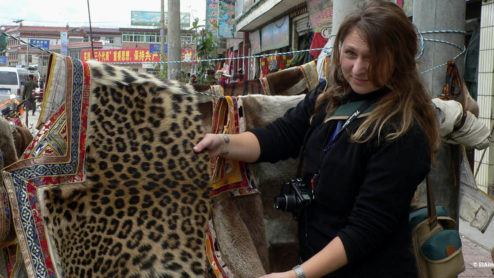 Debbie Banks with a leopard skin garment in Asia