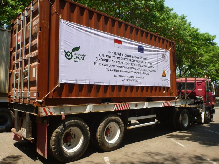 A truck loaded with a timber container covered with a banner - First Trial Shipment Timber Export to Anwerp - 2012-10-23