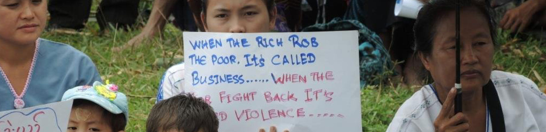 Demonstrators in Myanmar hold up signs protesting against the palm oil industry