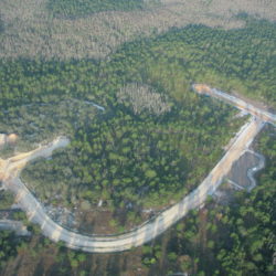 An aerial view of a forest intersected by a road